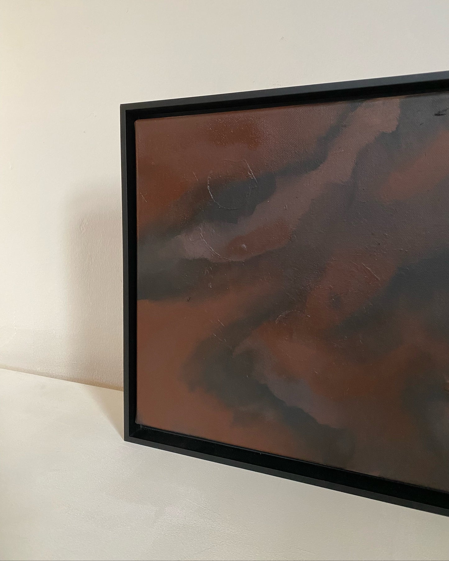 Small abstract painting in burnt sienna interior 2026